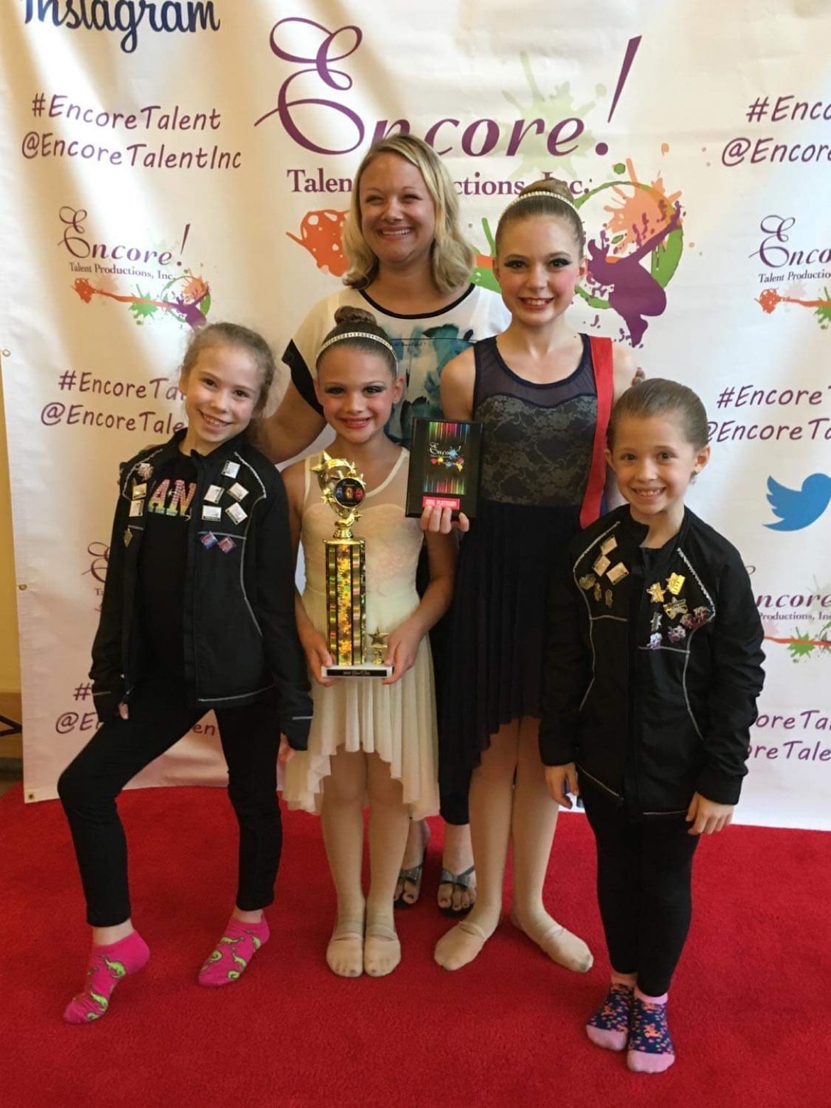 Turn Out Dance Academy dancers and instructor posing with an Encore award