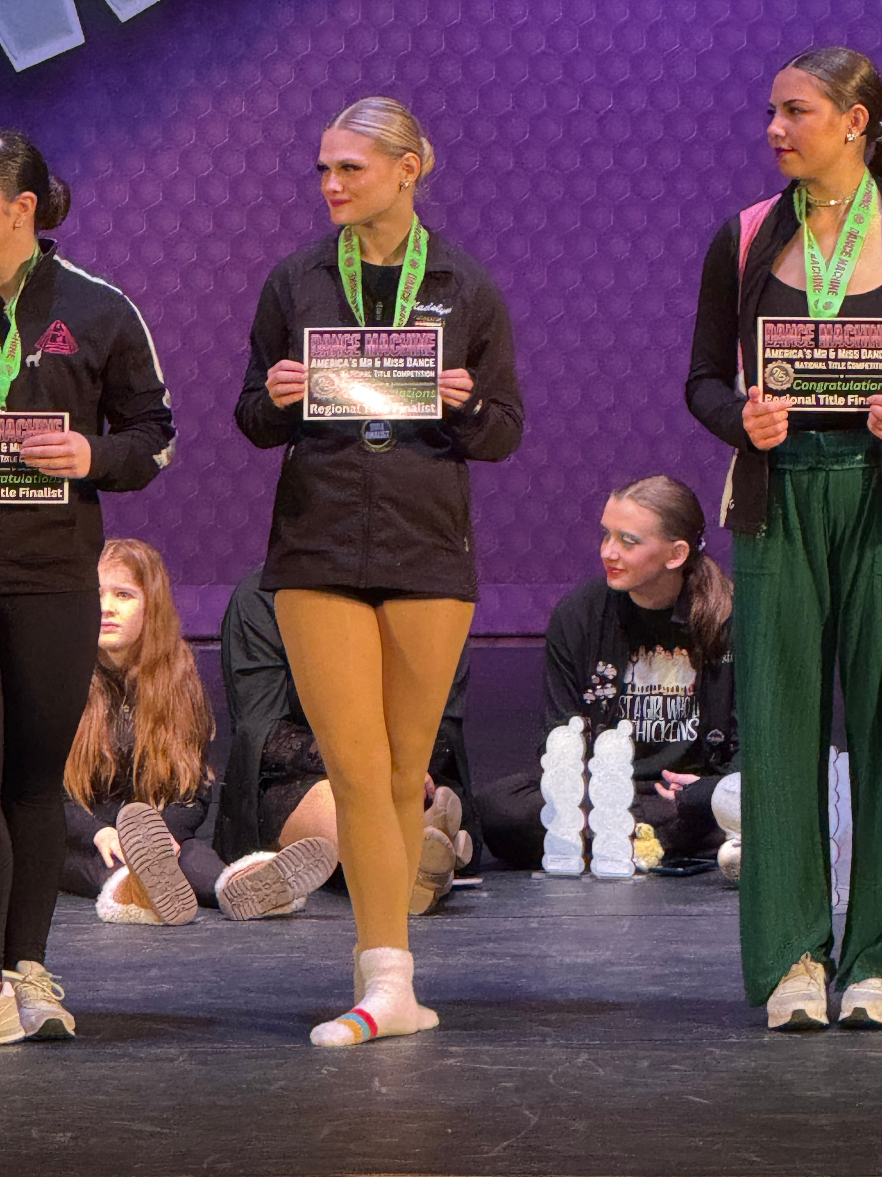 Turn Out Dance Academy performers holding awards on stage
