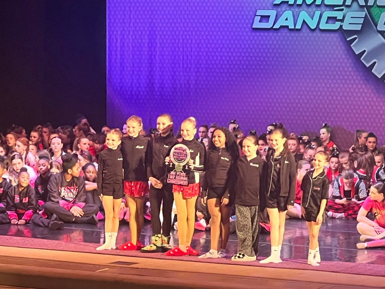 Turn Out Dance Academy dancers receiving a trophy on stage