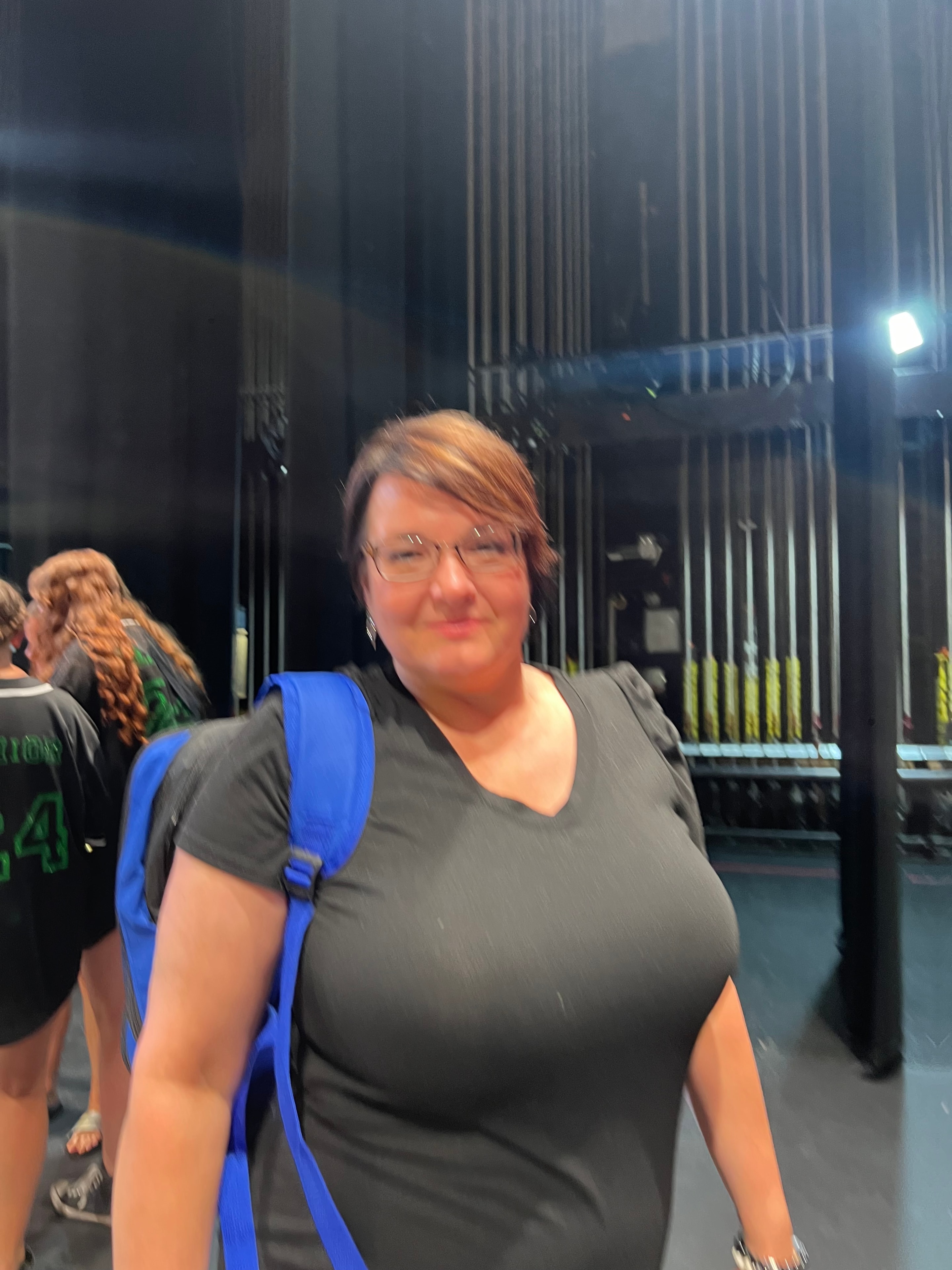 Turn Out Dance Academy team member smiling backstage at a performance venue
