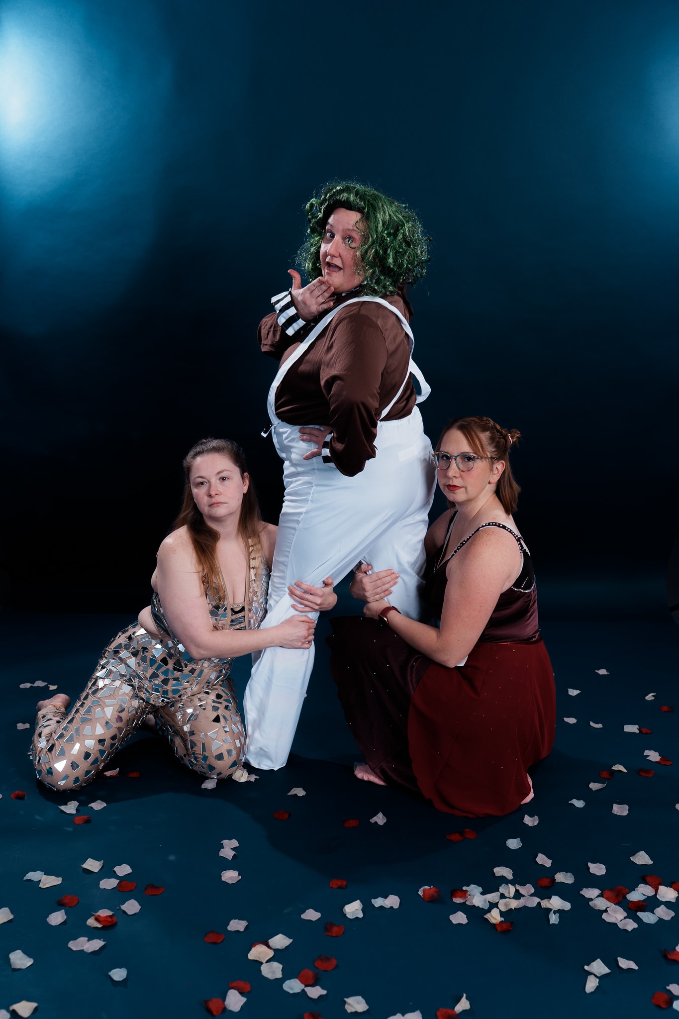 Three Turn Out Dance Academy performers posing playfully on a confetti-covered stage