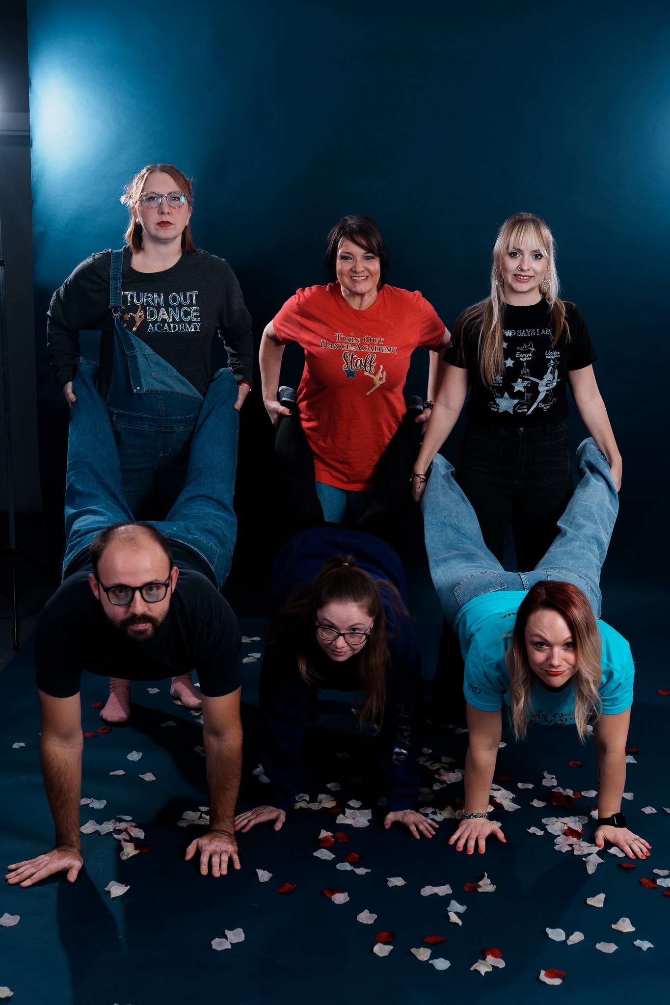 Turn Out Dance Academy staff and dancers posing together in a playful studio portrait