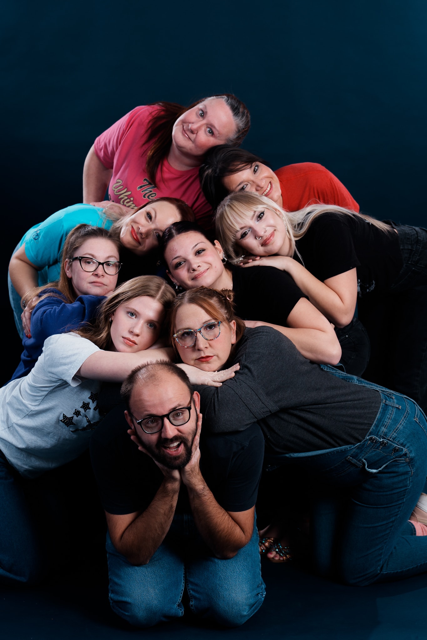 Turn Out Dance Academy staff and dancers posing together in a playful studio portrait