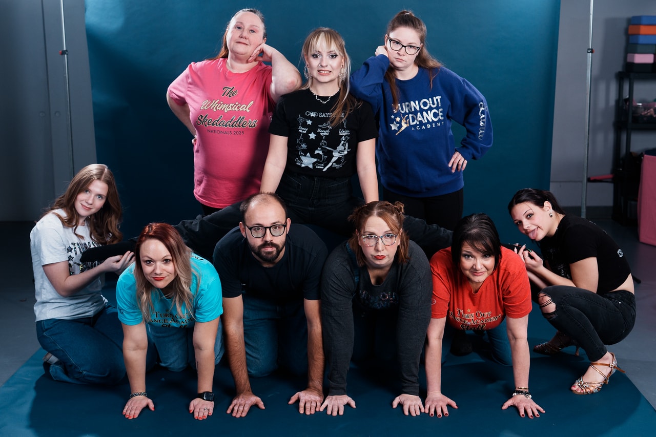 Turn Out Dance Academy staff and dancers posing together in the studio