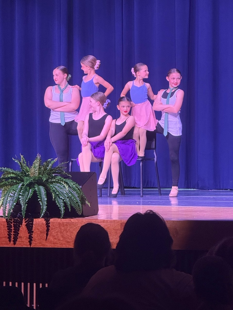 Turn Out Dance Academy dancers performing on stage under blue and pink lighting
