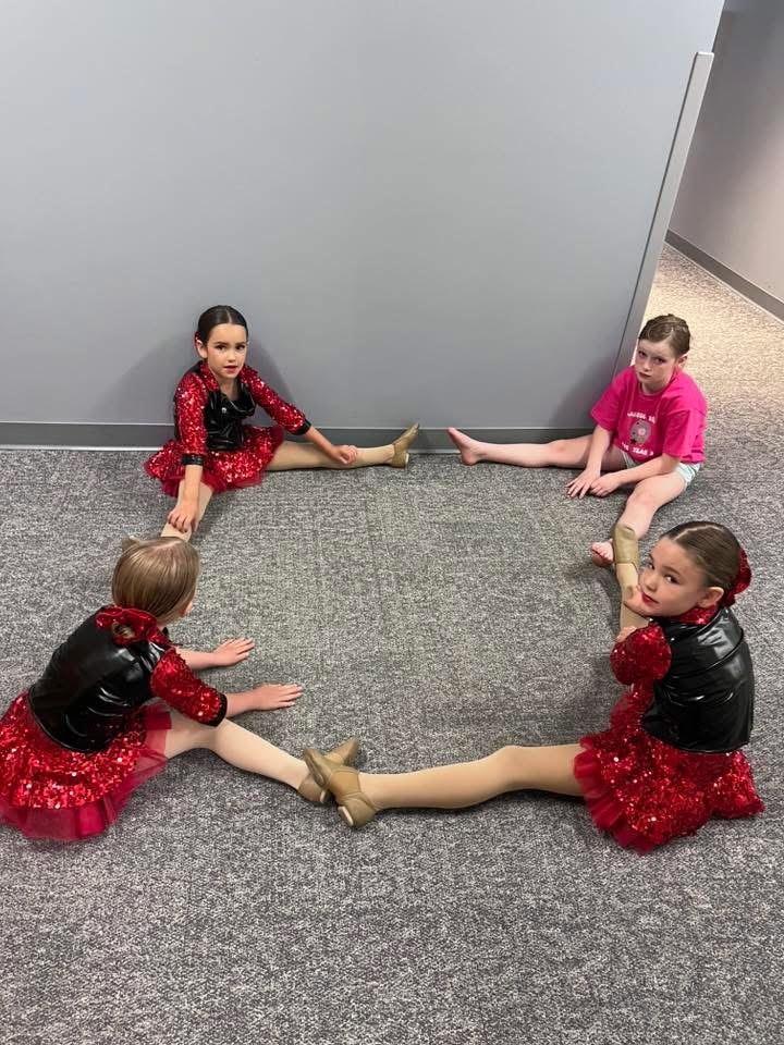 Young dancers performing together on stage at a recital