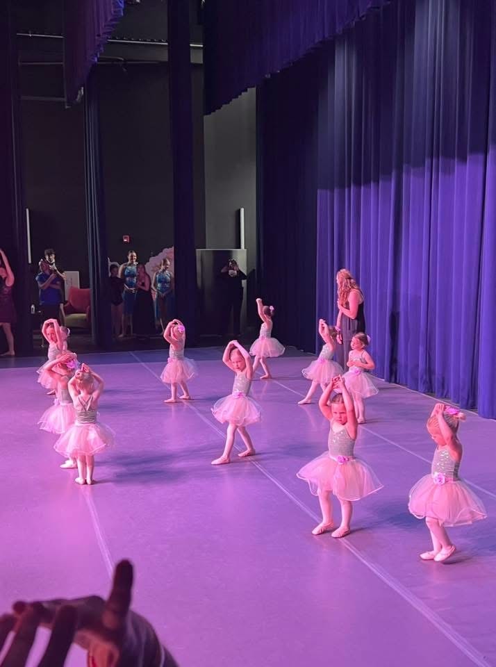 Young ballerinas performing on stage at a Turn Out Dance Academy recital