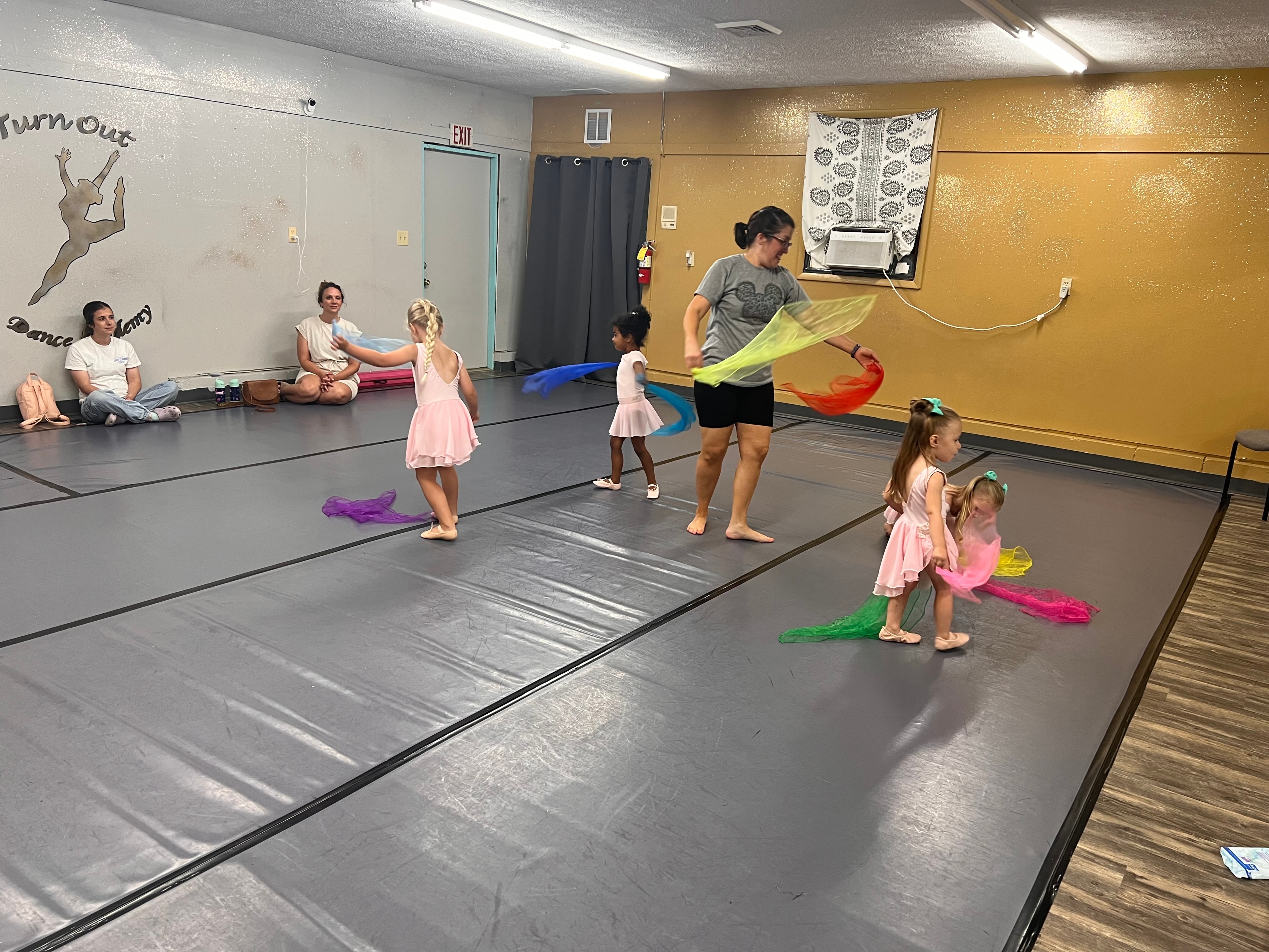 Young dancers exploring movement with colorful scarves in class