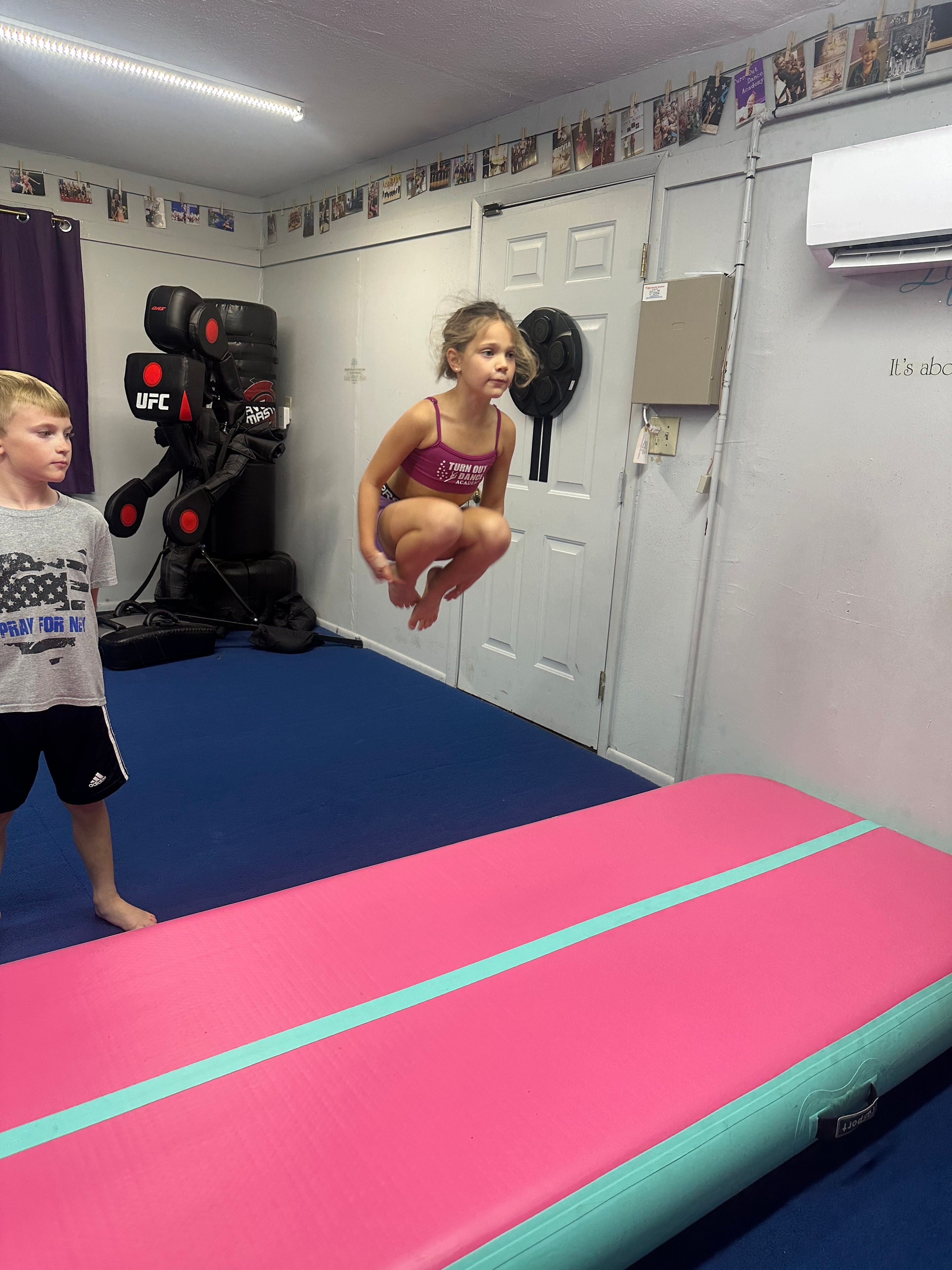 Young dancers preparing to practice tumbling together
