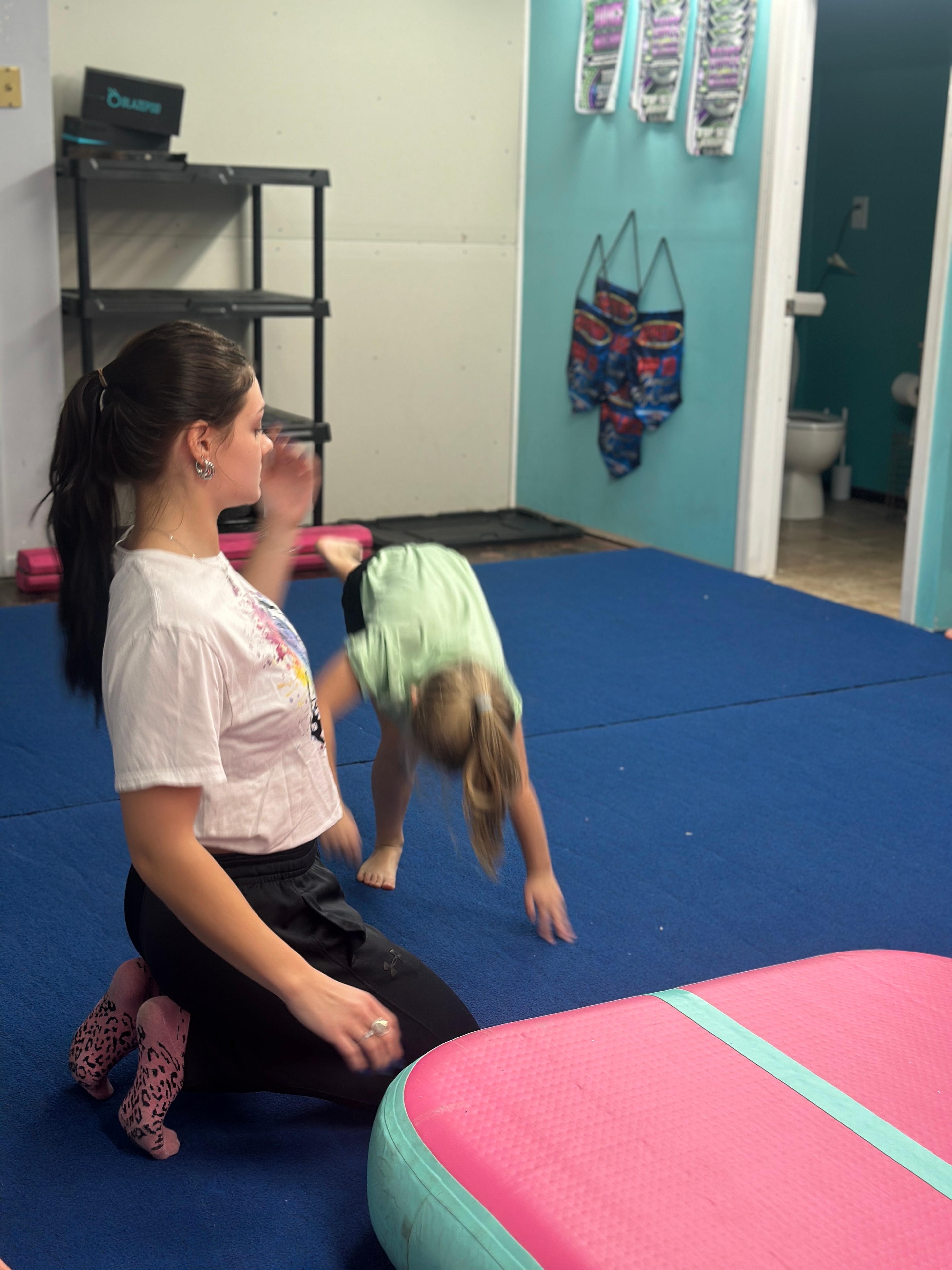 Young dancer practicing a tumbling skill in the studio